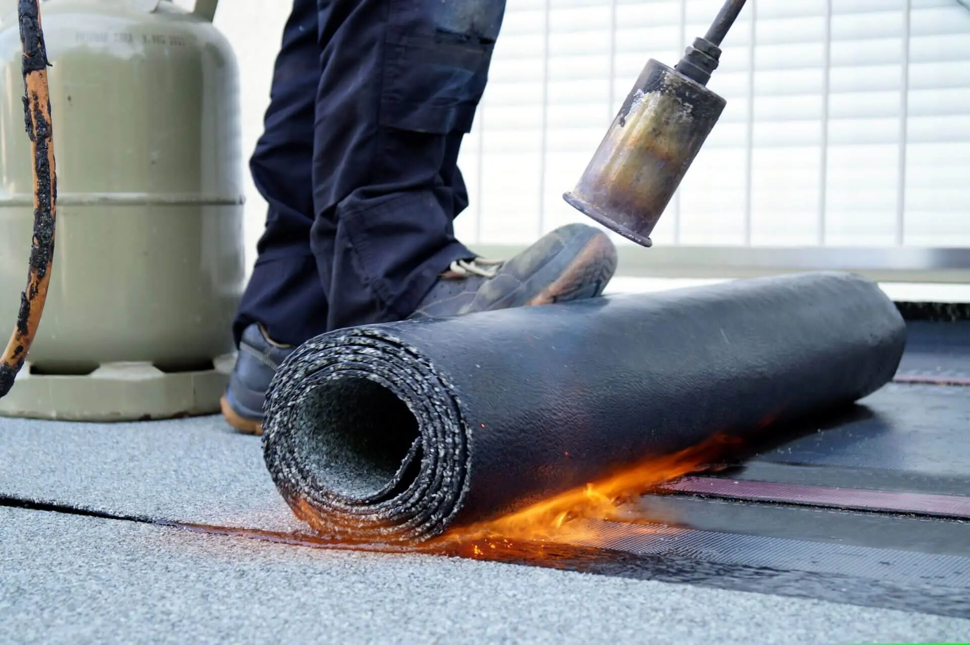 A person is using an air gun to cut the floor.