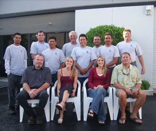 Group of people posing outside a building.