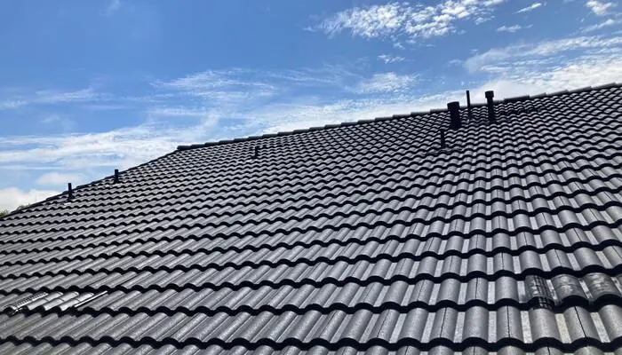 Gray tiled roof under a blue sky.