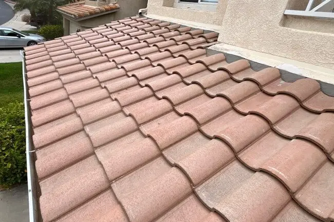 Red clay roof tiles on residential house.