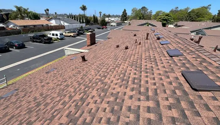 Rooftop view overlooking suburban neighborhood and parking.
