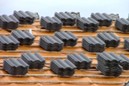 A bunch of black bricks on top of a roof